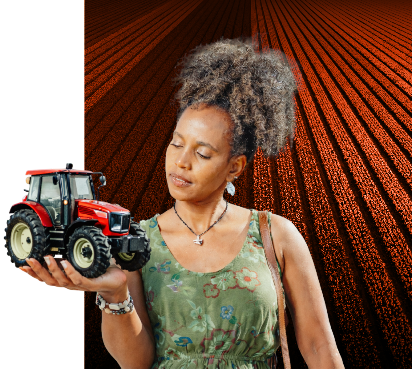 Woman holding a model tractor in front of a furrowed-field deep-rust block